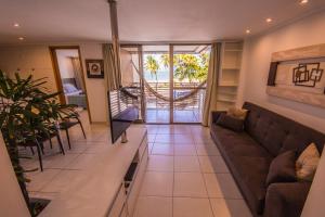 a living room with a couch and a table at Luxor Cabo Branco Home Service in João Pessoa