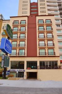 a large apartment building with a sign in front of it at Astur Hotel & Residence in Veracruz