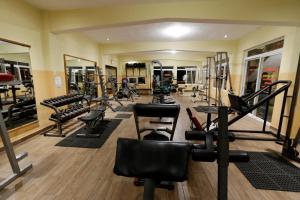 a gym with lots of treadmills and machines at El Delfin Hotel y Restaurante in San Pedro La Laguna