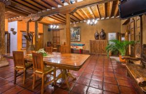 a dining room with a wooden table and chairs at Hotel Refugio del Angel in Pátzcuaro