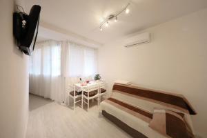 a room with a bed and a table in it at Apartment Luci in Zadar