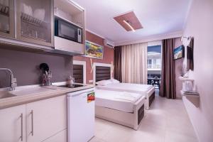a kitchen with a sink and a microwave at House Katerina Mediterranean in Sarti