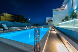 ein Schwimmbad in einem Haus in der Nacht in der Unterkunft Villa Franica in Zadar