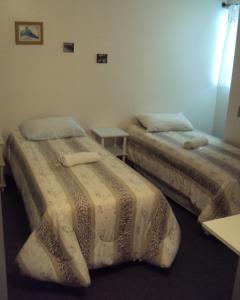 מיטה או מיטות בחדר ב-Pousada Dona Luiza