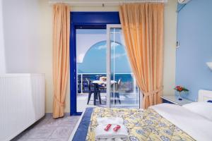 a hotel room with a bed and a view of the ocean at House Katerina Mediterranean in Sarti
