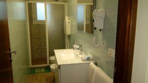 a bathroom with a sink and a toilet and a mirror at New Prophet Appartamenti in Cattolica +43 photos