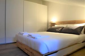 a bedroom with a large bed with white sheets at A 48 passi dalle 5 Terre in Riccò del Golfo di Spezia +33 photos