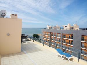 a blue chair on the balcony of a building at Fun & Sun Apartment in Olhão