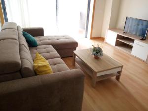 a living room with a couch and a coffee table at Fun & Sun Apartment in Olhão