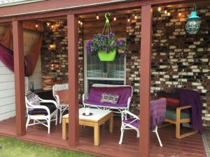 a gazebo with chairs and a table at Rose Cottage Bed & Breakfast in Valemount