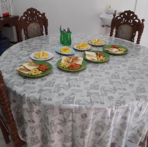 a table with plates of food on it at Arriani Homestay in Karimunjawa