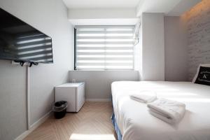 Postel nebo postele na pokoji v ubytování K-Guesthouse Seomyeon 1