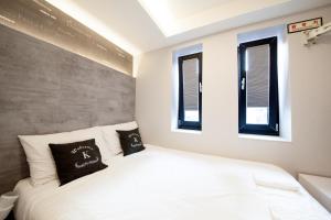 Postel nebo postele na pokoji v ubytování K-Guesthouse Seomyeon 1