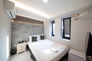 Postel nebo postele na pokoji v ubytování K-Guesthouse Seomyeon 1