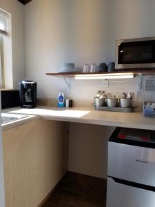 a kitchen with a counter top with a microwave at Escalante Cabins & RV Park in Escalante