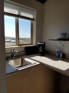 a kitchen with a sink and a window at Escalante Cabins & RV Park in Escalante