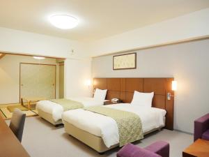 เตียงในห้องที่ Wisterian Life Club Usami