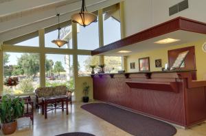 a lobby with a waiting area with a large window at Rodeway Inn in Santa Clara