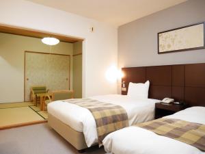 เตียงในห้องที่ Wisterian Life Club Usami