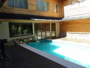 a swimming pool in front of a house at Las Golondrinas - UF 319 in San Martín de los Andes