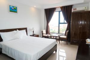 Postel nebo postele na pokoji v ubytování Aries Hotel
