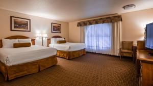 a hotel room with two beds and a television at Best Western El Grande Inn in Clearlake +12 photos