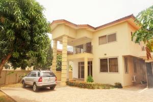 a car parked in front of a house at Sandpark Place, West Hills in Accra