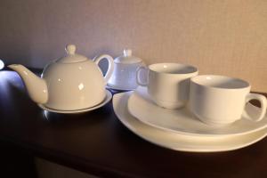 uma mesa preta com duas chávenas e pires. em Grand Hotel em Ulyanovsk