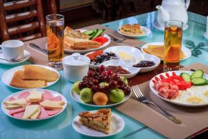 a blue table with plates of food on it at City Line Boutique Hotel in Tashkent