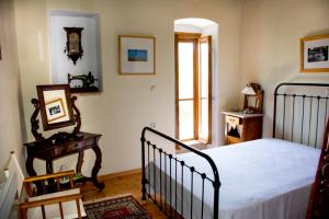 a bedroom with a bed and a clock on the wall at Nostos Residence - Apartment Terra in Tselendáta