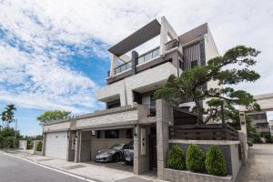 a house with a car parked in front of it at Rainbow in Ji'an