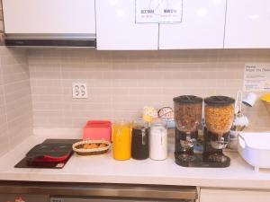 a kitchen counter with a blender and other ingredients at K-Guesthouse Seomyeon 1 in Busan