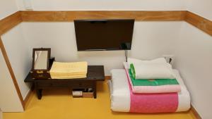 Postel nebo postele na pokoji v ubytování Sohyundang Guesthouse