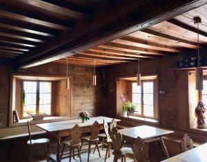 a dining room with wooden ceilings and tables and chairs at Obersteinerhof in Collalbo +11 photos