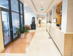 an empty hallway in a hospital with potted plants at Domus Helena in Rome