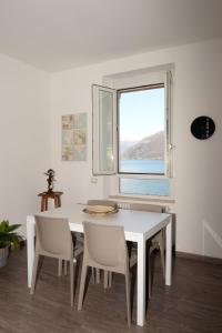 ベッラーノにあるCasa Luisaの窓付きの客室で、白いテーブルと椅子が備わります。