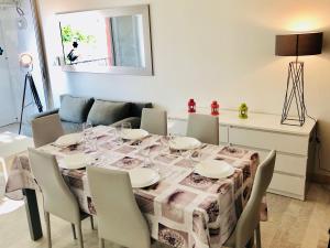 a dining room with a table and chairs at 3 plan des boucaniers in Cap d'Agde