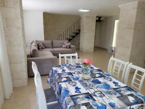 a living room with a table and a couch at Luxury duplex Armand Durres in Golem