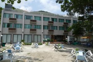 a building with chairs and tables in front of it at Seaview Holiday Resort in Hong Kong