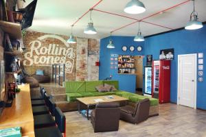 a living room with a green couch and a table at Rolling Stones hostel in Irkutsk