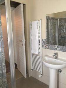 a bathroom with a sink and a mirror at Delzanno in Varallo
