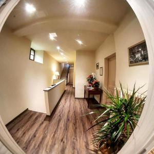 a hallway of an office with a circular mirror at Delzanno in Varallo