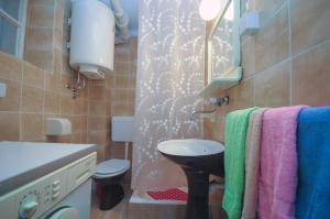 a bathroom with a sink and a toilet and towels at Apartment Lucky in Budva +49 photos