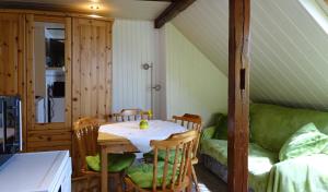 a room with a table and chairs and a couch at Pension im Glück Thale in Thale
