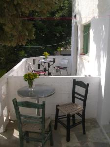 a patio with two chairs and a table and two tables at Gabriellas Garden in Palaiokastro