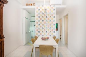 a dining room with a white table and chairs at Casa dell'Isola Bella Taormina mare in Taormina