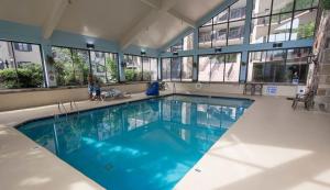 a large swimming pool with blue water in a building at Heart of Gatlinburg, sleep 6 in Gatlinburg