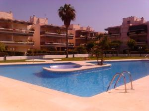 a large swimming pool in front of a building at Playa y Sol in Cubelles