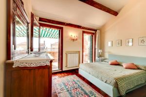 a bedroom with a bed and a window at Biennale Terrace Apt in Venice