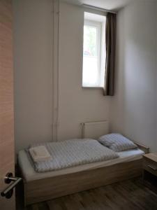 A bed or beds in a room at MATE Apartmanok